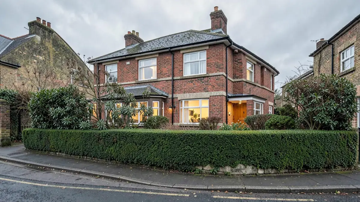A finished Clarendon house behind its front hedge